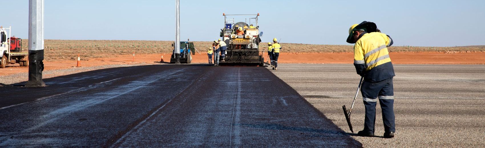 Bituminous Products and Services Road workers and machinery laying Downer Group's Bituminous products