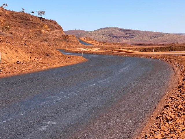 Haul road in dry weather conditions with Haulpac applied to it, a Bitumen Emulsion.