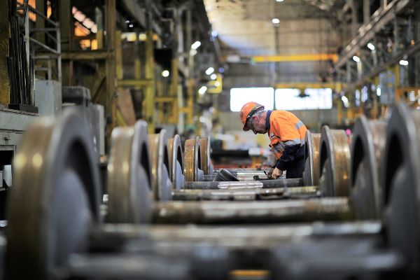 A Downer employee working on bogies at the Maryborough rail factory